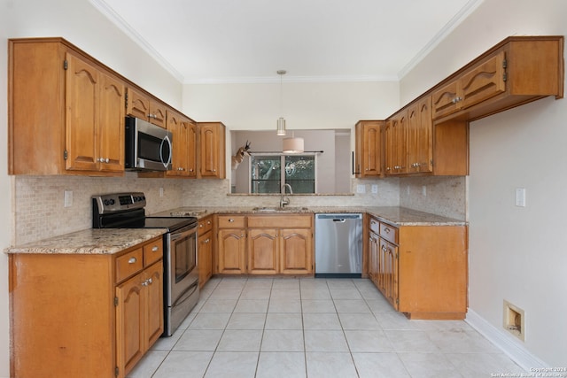 kitchen featuring decorative light fixtures, crown molding, stainless steel appliances, sink, and light stone counters