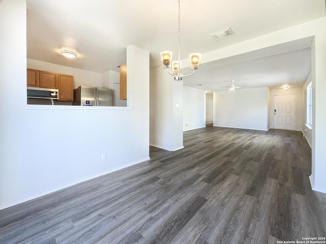 interior space featuring visible vents, baseboards, dark wood-style floors, and ceiling fan with notable chandelier