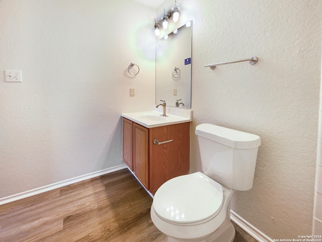 bathroom featuring hardwood / wood-style floors, toilet, and vanity