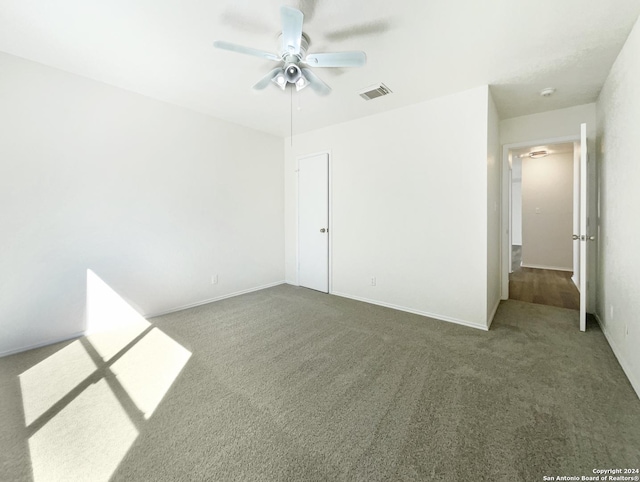 unfurnished bedroom with visible vents, baseboards, carpet, and ceiling fan