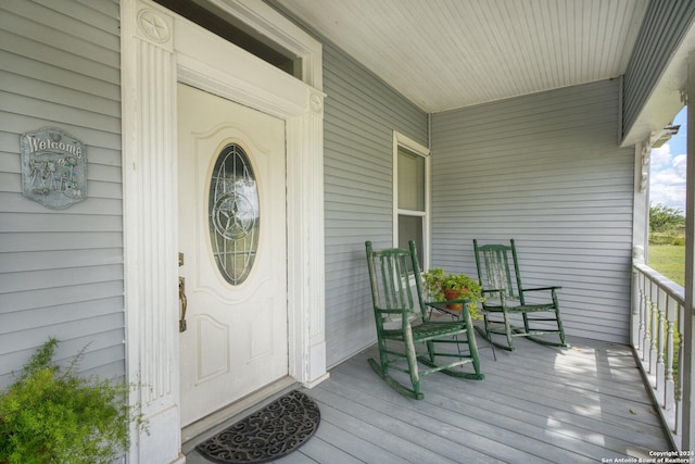 view of exterior entry featuring covered porch