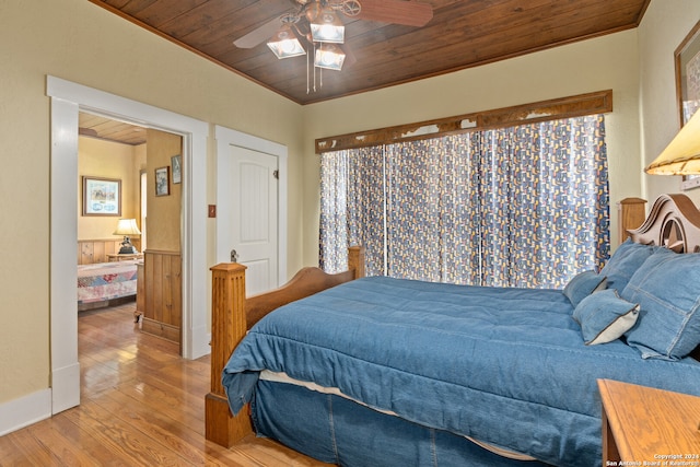 bedroom with ceiling fan, crown molding, wood-type flooring, and wooden ceiling