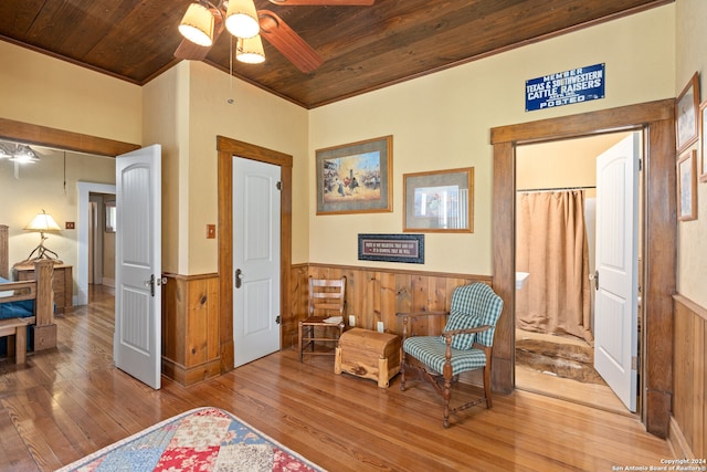 living area with wooden ceiling, wood-type flooring, and ceiling fan