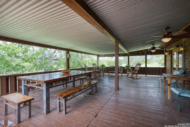 deck featuring outdoor dining area and a ceiling fan