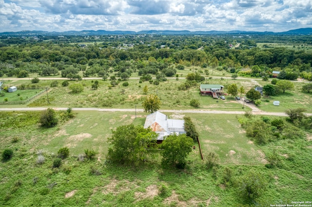 birds eye view of property with a mountain view and a rural view