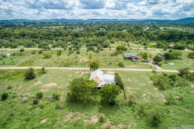 aerial view featuring a rural view, a mountain view, and a view of trees