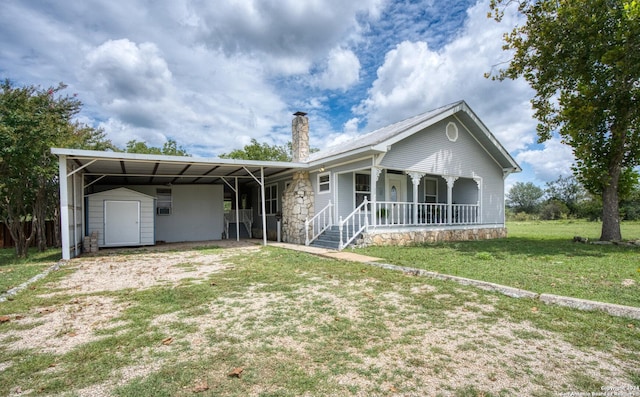 single story home with an attached carport, a porch, a front yard, a chimney, and an outdoor structure