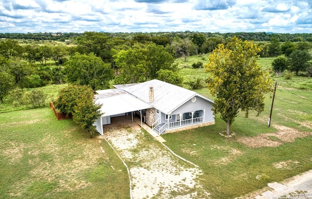 drone / aerial view featuring a forest view