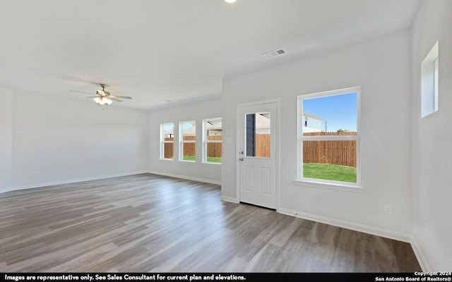 empty room featuring hardwood / wood-style floors and ceiling fan