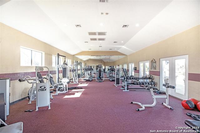 exercise room featuring lofted ceiling and french doors