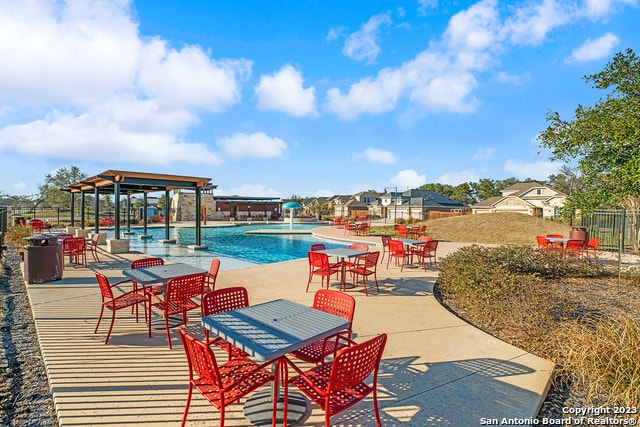 view of pool featuring pool water feature and a patio area