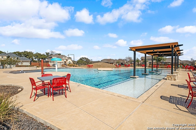 view of swimming pool with a patio area and pool water feature