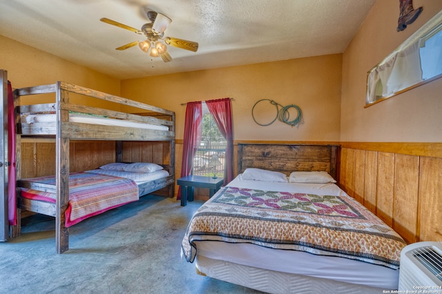 bedroom featuring ceiling fan, carpet, and a textured ceiling