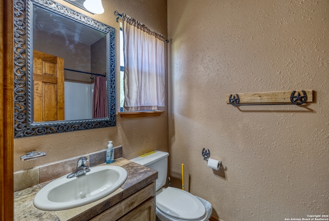 bathroom with vanity, toilet, and a shower with shower curtain