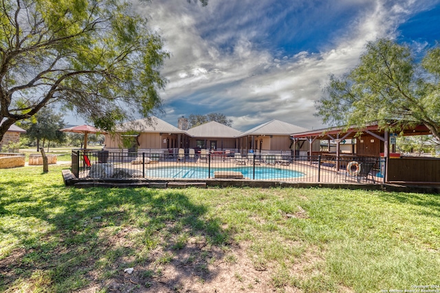 view of pool with a lawn and a patio