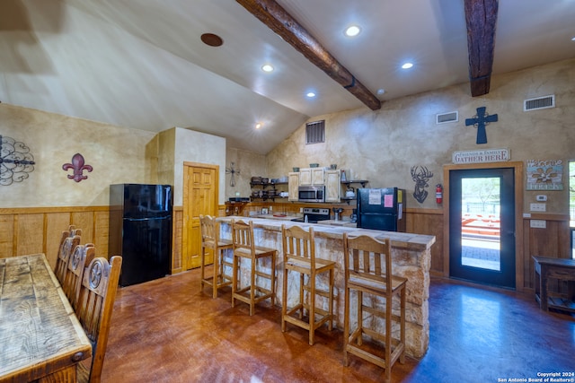 kitchen with a breakfast bar, stainless steel appliances, high vaulted ceiling, and beam ceiling