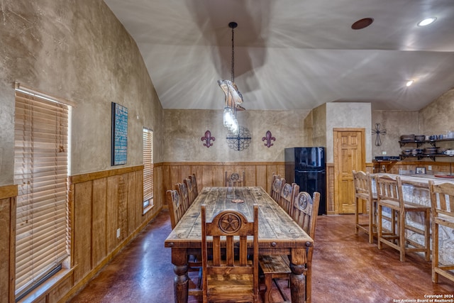 dining area featuring high vaulted ceiling