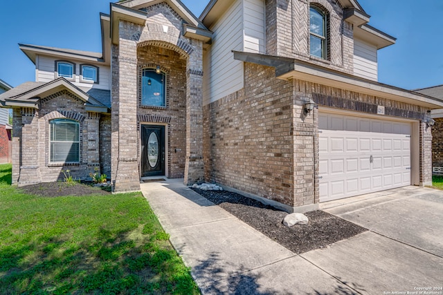 view of front of house featuring a garage and a front lawn