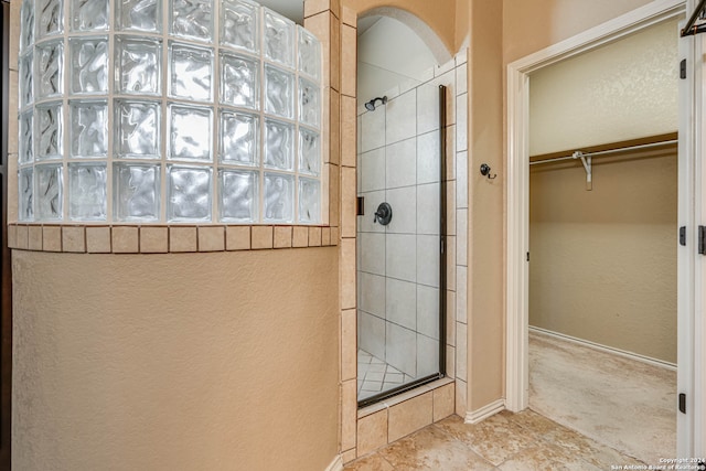 bathroom featuring tiled shower and tile patterned floors