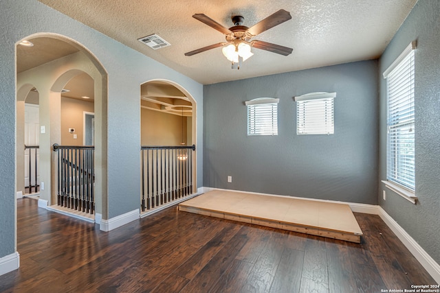 unfurnished room featuring hardwood / wood-style floors, ceiling fan, and a textured ceiling