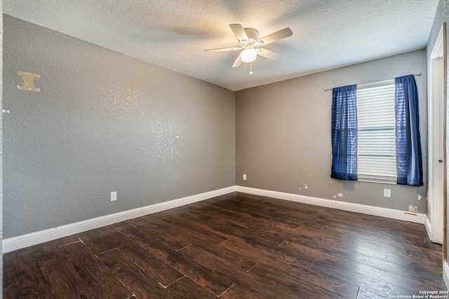 unfurnished room with dark wood-type flooring, a textured ceiling, and ceiling fan