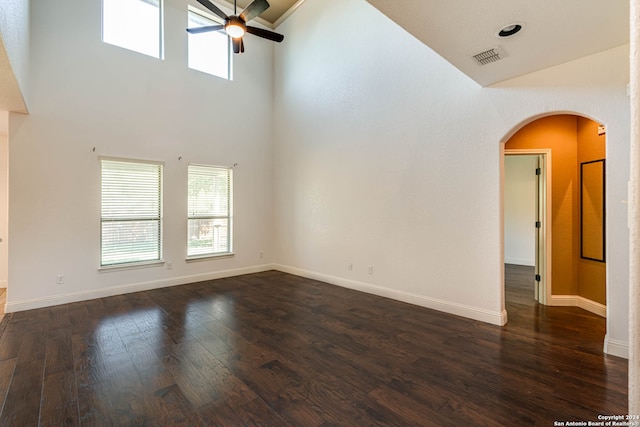 unfurnished room with ceiling fan, high vaulted ceiling, and dark hardwood / wood-style flooring