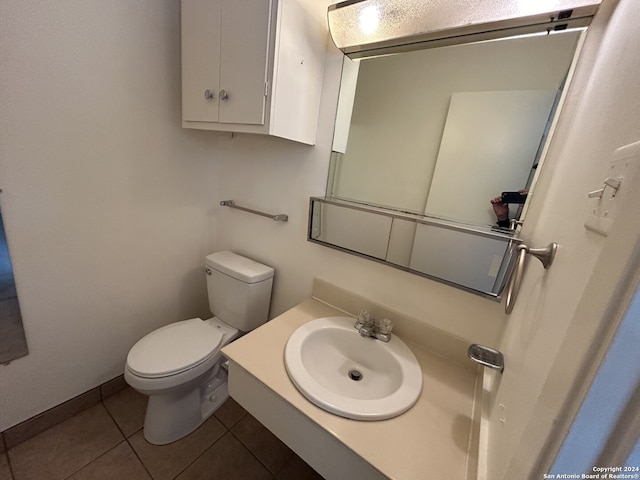 bathroom with tile patterned flooring, vanity, and toilet