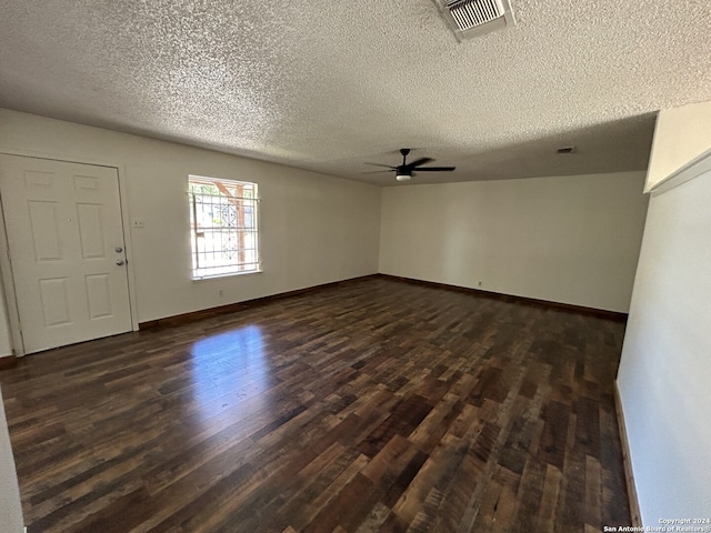 unfurnished room featuring a textured ceiling, dark wood-type flooring, and ceiling fan