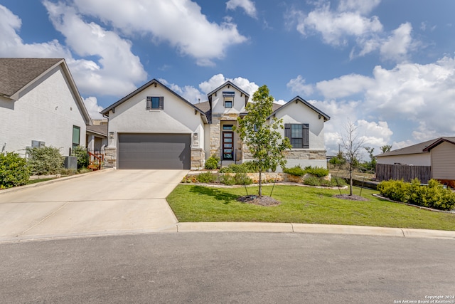 view of front of home featuring a garage and a front lawn