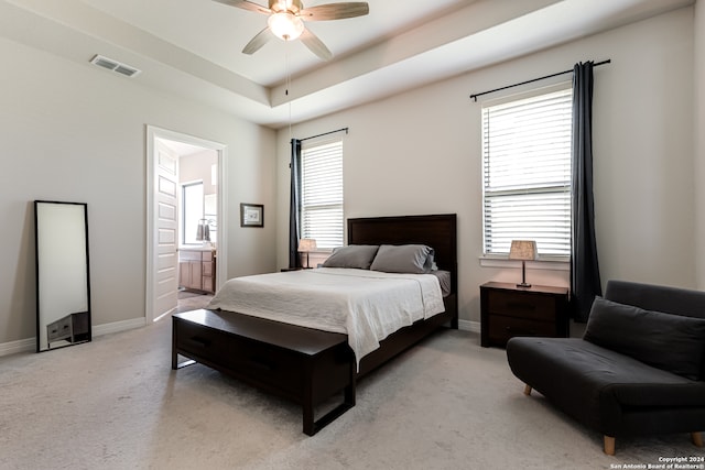 carpeted bedroom with ceiling fan and connected bathroom