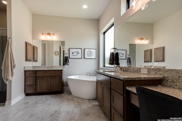 bathroom with vanity and a bath