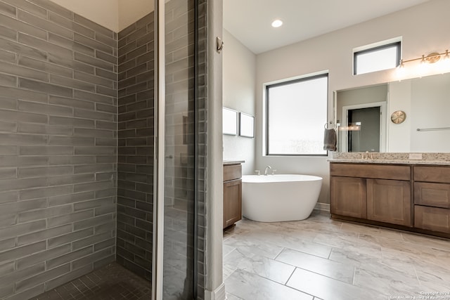 bathroom with vanity, a wealth of natural light, and separate shower and tub