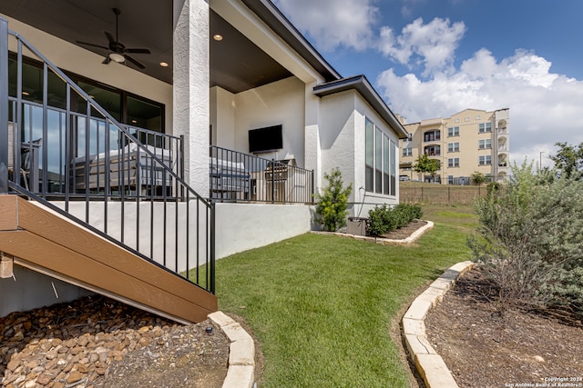 exterior space with ceiling fan