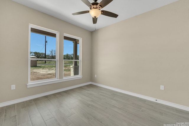 spare room featuring ceiling fan and light hardwood / wood-style floors