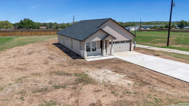 view of front of house featuring a garage and a front lawn