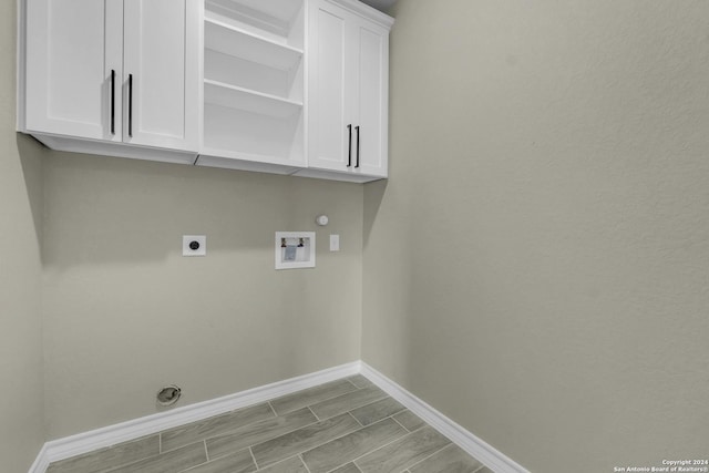 16118 Vaquero Dr, Atascosa, TX 78002 - washroom with electric dryer hookup, washer hookup, baseboards, cabinet space, and gas dryer hookup