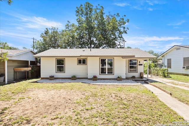 rear view of house featuring a yard