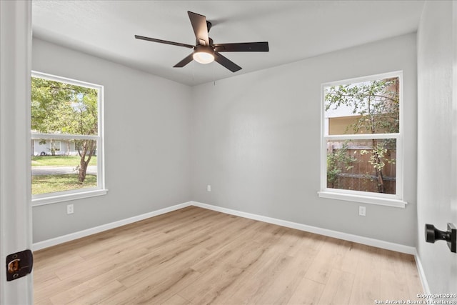 empty room with light hardwood / wood-style flooring and a wealth of natural light