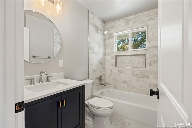 full bathroom with tiled shower / bath, vanity, and toilet