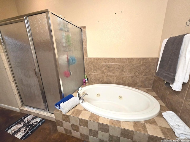 bathroom featuring shower with separate bathtub