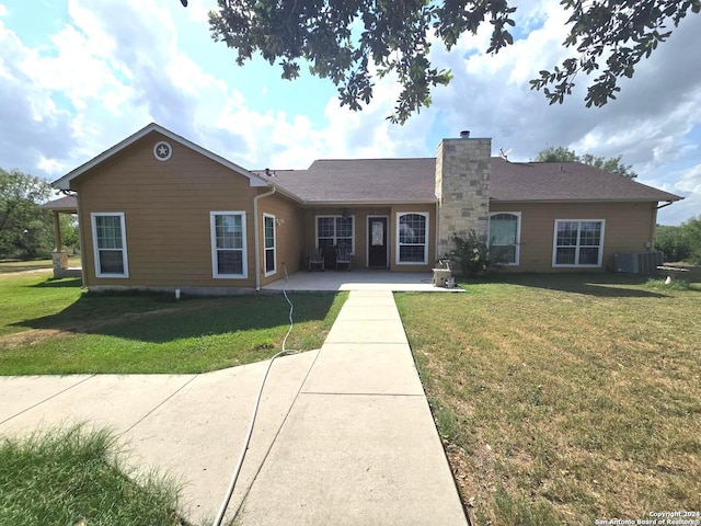 single story home featuring a front lawn and central air condition unit