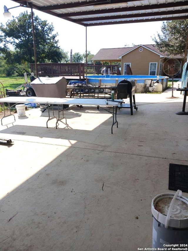 view of patio featuring a pergola and an empty pool