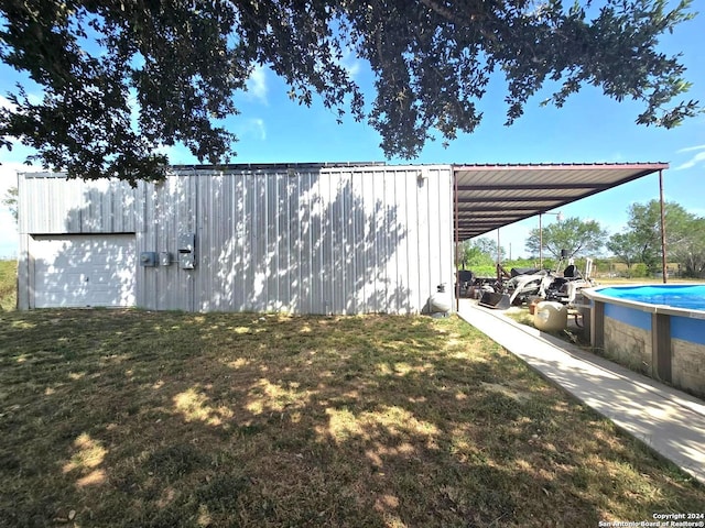 view of yard with an outdoor structure and a carport