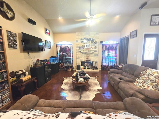 living room featuring ceiling fan, a fireplace, wood-type flooring, and vaulted ceiling