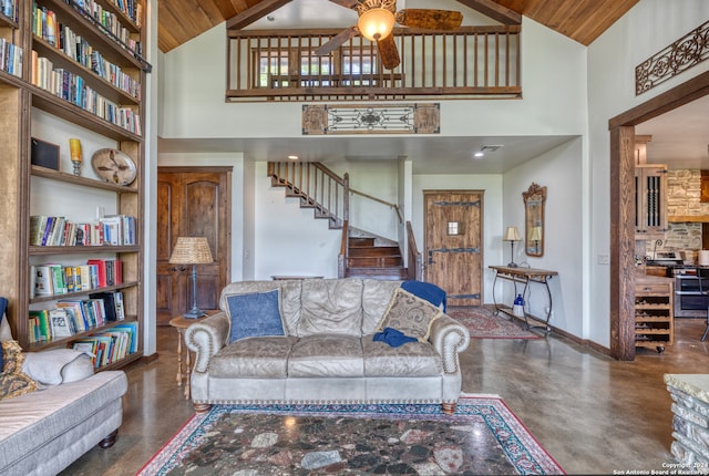 living room with wood ceiling, high vaulted ceiling, and ceiling fan