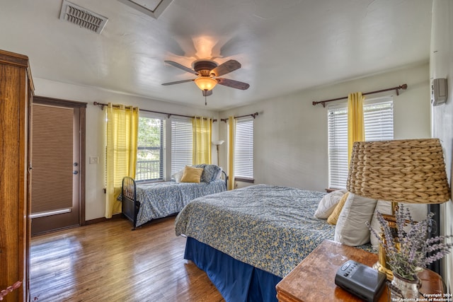 bedroom with hardwood / wood-style floors and ceiling fan