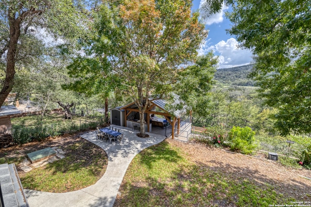 view of yard featuring a gazebo, a patio, and a mountain view