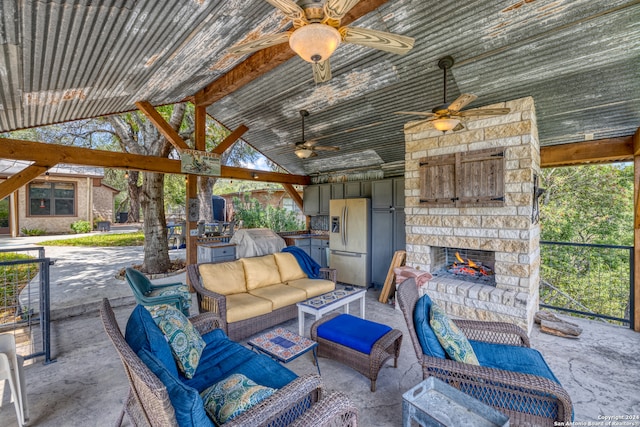 view of patio with a grill, ceiling fan, and an outdoor living space with a fireplace