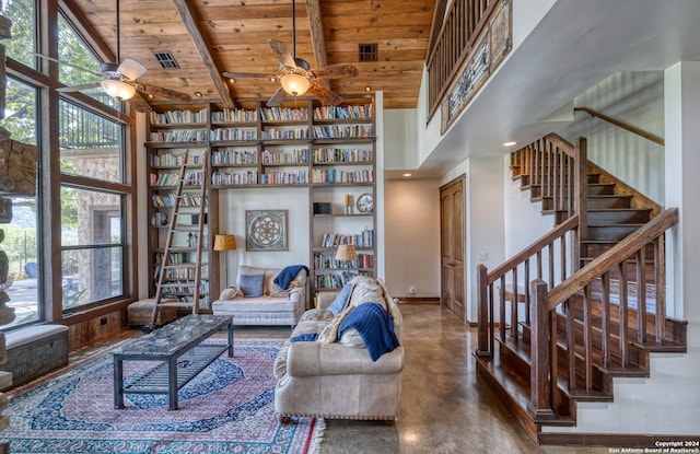 living room with concrete floors, wooden ceiling, ceiling fan, high vaulted ceiling, and beam ceiling