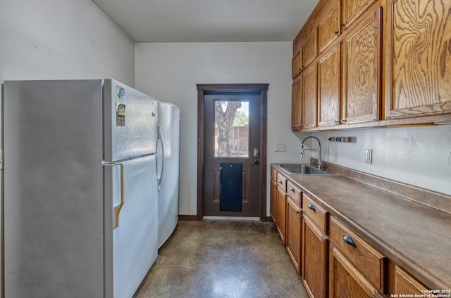 kitchen featuring white fridge and sink